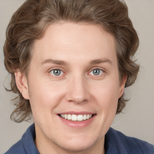 Joyful white young-adult female with medium  brown hair and blue eyes