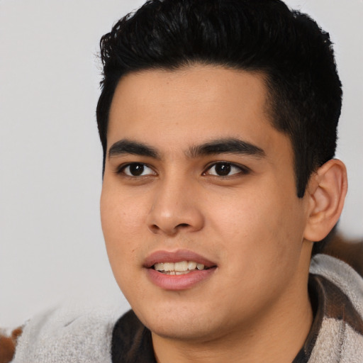 Joyful asian young-adult male with short  black hair and brown eyes