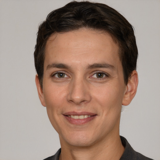 Joyful white adult male with short  brown hair and grey eyes