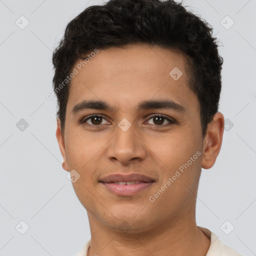 Joyful latino young-adult male with short  brown hair and brown eyes