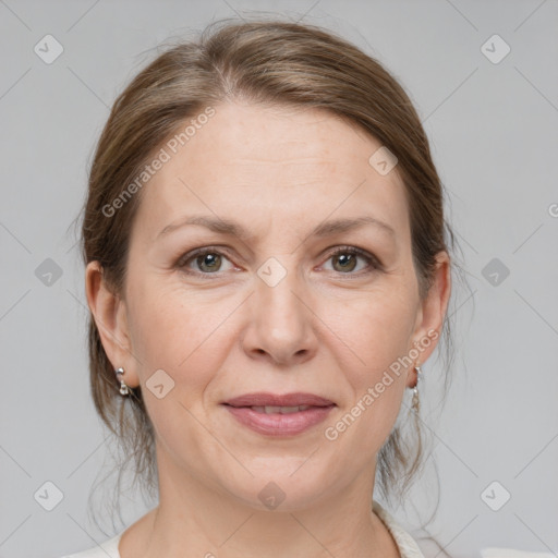 Joyful white adult female with medium  brown hair and grey eyes