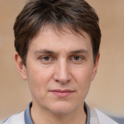 Joyful white adult male with short  brown hair and brown eyes