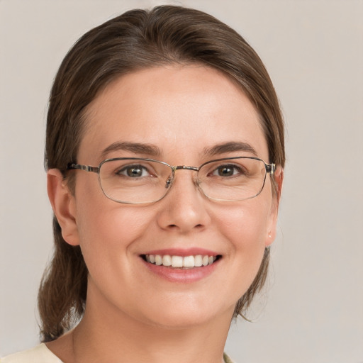 Joyful white young-adult female with medium  brown hair and brown eyes