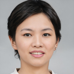 Joyful asian young-adult female with medium  brown hair and brown eyes