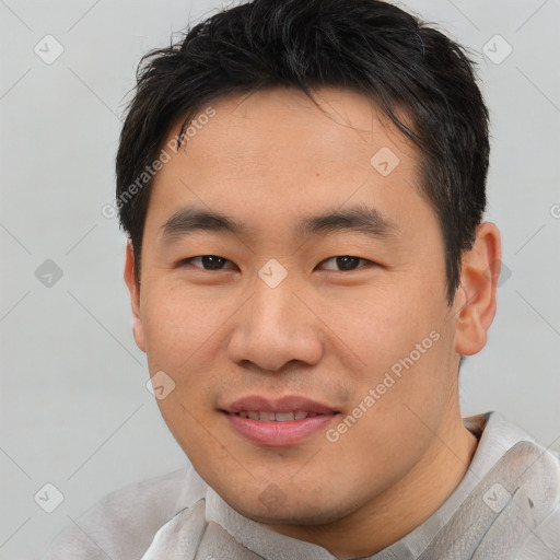 Joyful asian young-adult male with short  brown hair and brown eyes