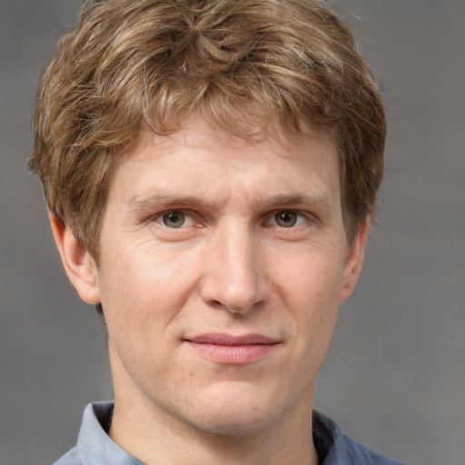 Joyful white adult male with short  brown hair and grey eyes