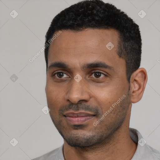 Joyful black young-adult male with short  black hair and brown eyes