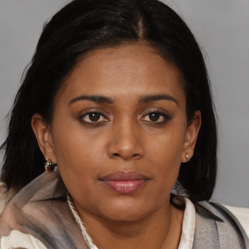 Joyful black young-adult female with medium  brown hair and brown eyes