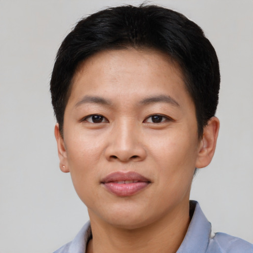 Joyful asian young-adult female with short  brown hair and brown eyes