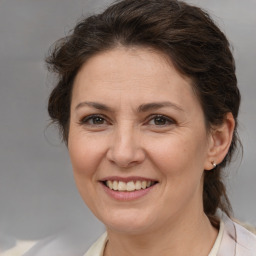 Joyful white adult female with medium  brown hair and brown eyes