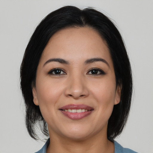 Joyful latino young-adult female with medium  black hair and brown eyes