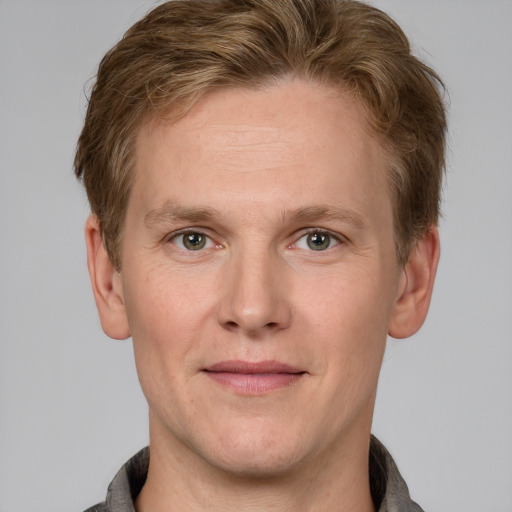 Joyful white adult male with short  brown hair and grey eyes