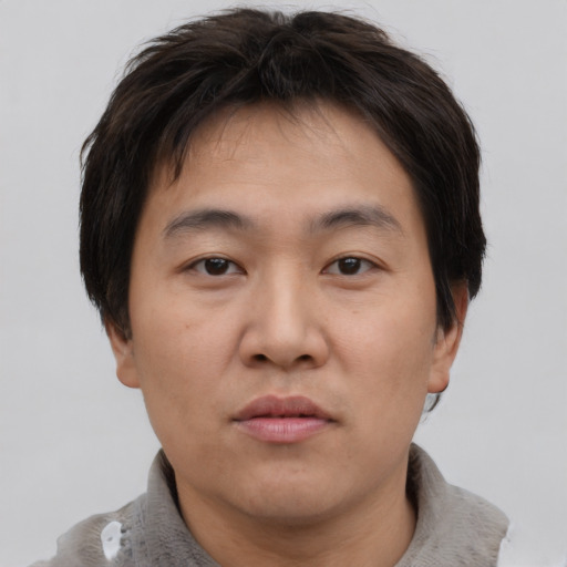 Neutral asian young-adult male with short  brown hair and brown eyes