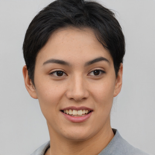 Joyful asian young-adult female with short  brown hair and brown eyes