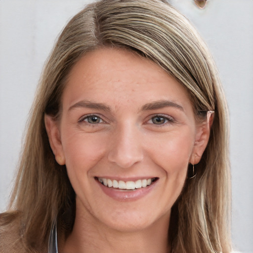 Joyful white young-adult female with long  brown hair and grey eyes