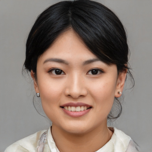 Joyful asian young-adult female with medium  black hair and brown eyes