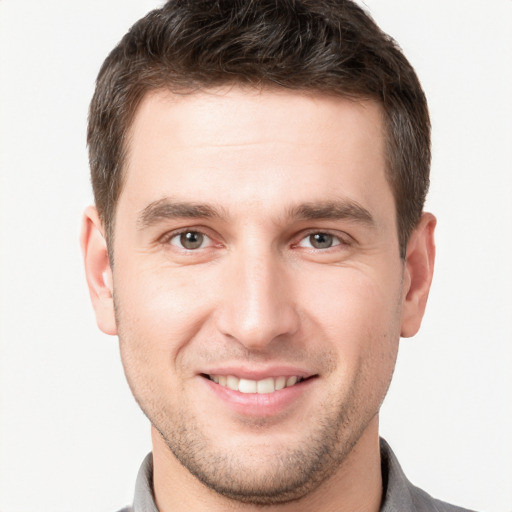 Joyful white young-adult male with short  brown hair and brown eyes