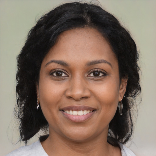 Joyful black young-adult female with medium  brown hair and brown eyes