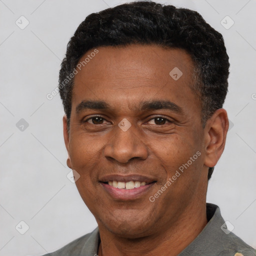 Joyful latino adult male with short  black hair and brown eyes