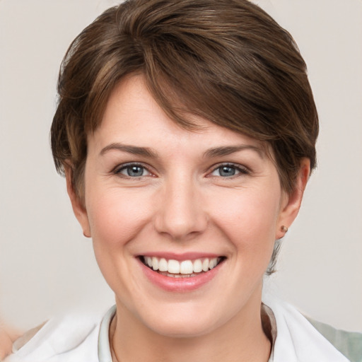 Joyful white young-adult female with short  brown hair and grey eyes