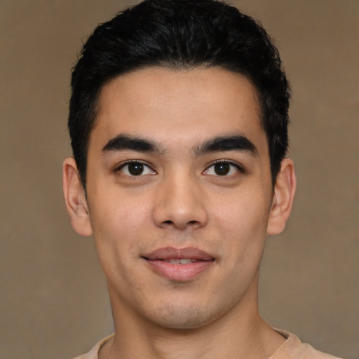 Joyful latino young-adult male with short  black hair and brown eyes