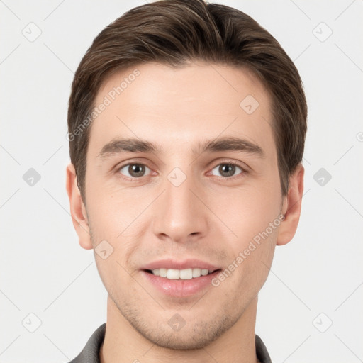 Joyful white young-adult male with short  brown hair and grey eyes