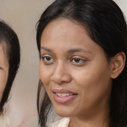 Joyful latino adult female with medium  brown hair and brown eyes