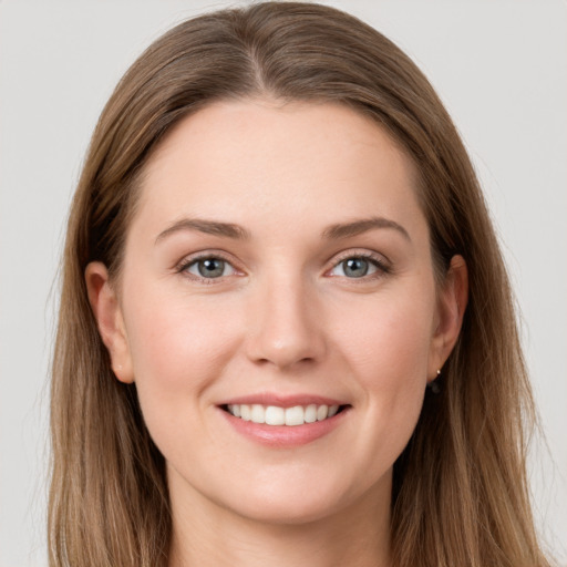 Joyful white young-adult female with long  brown hair and grey eyes