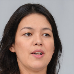 Joyful asian adult female with medium  brown hair and brown eyes