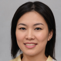 Joyful asian young-adult female with medium  brown hair and brown eyes