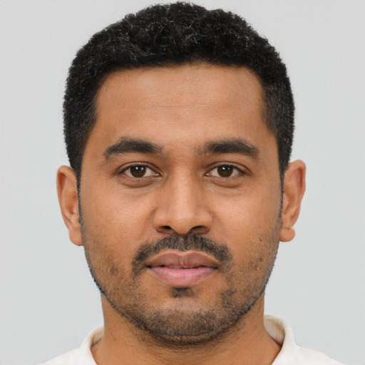 Neutral latino young-adult male with short  black hair and brown eyes