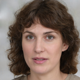 Joyful white young-adult female with medium  brown hair and green eyes