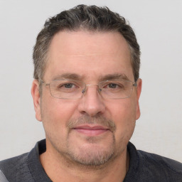 Joyful white adult male with short  brown hair and grey eyes