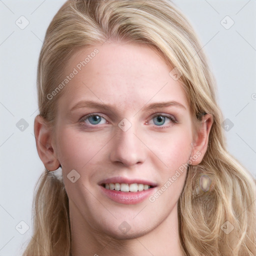 Joyful white young-adult female with long  brown hair and blue eyes