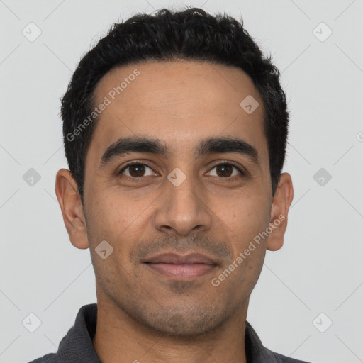 Joyful latino young-adult male with short  black hair and brown eyes