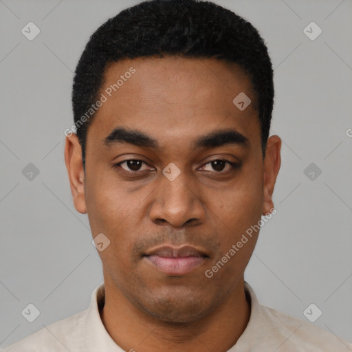 Joyful black young-adult male with short  black hair and brown eyes