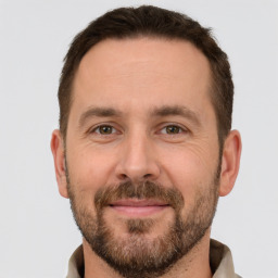 Joyful white adult male with short  brown hair and brown eyes