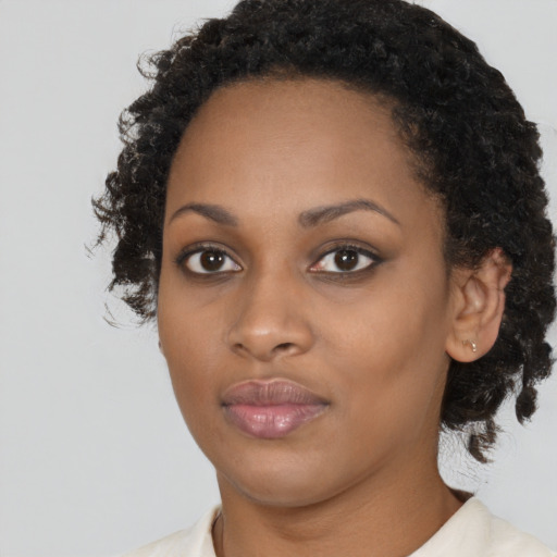 Neutral black young-adult female with medium  brown hair and brown eyes