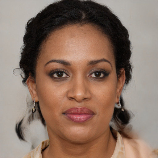 Joyful black young-adult female with medium  brown hair and brown eyes
