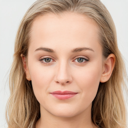 Joyful white young-adult female with long  brown hair and blue eyes