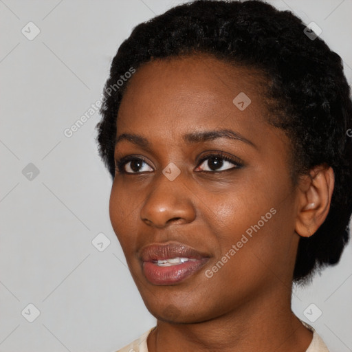 Joyful black young-adult female with short  black hair and brown eyes