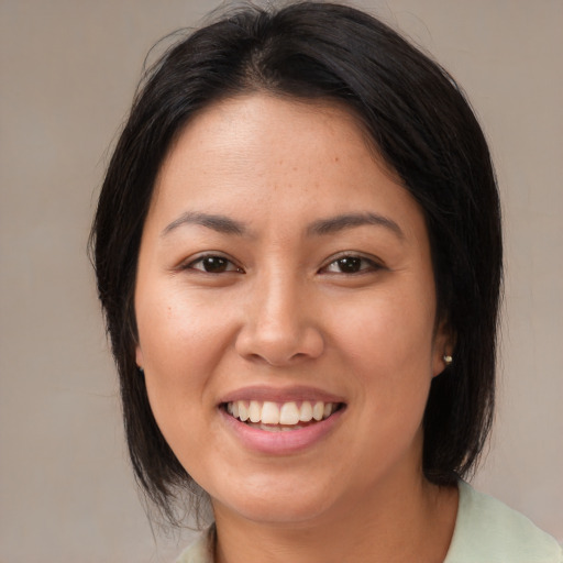 Joyful asian young-adult female with medium  brown hair and brown eyes