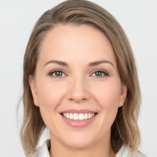 Joyful white young-adult female with medium  brown hair and grey eyes