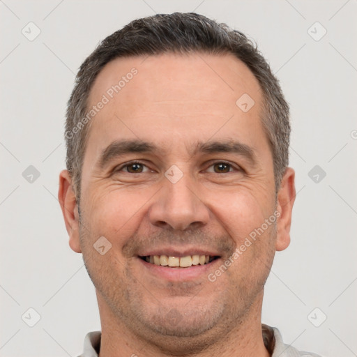 Joyful white adult male with short  brown hair and brown eyes