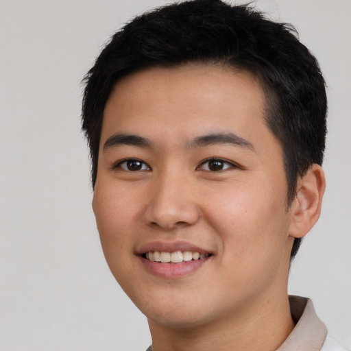 Joyful asian young-adult male with short  black hair and brown eyes