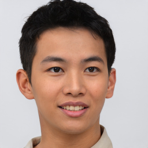Joyful asian young-adult male with short  brown hair and brown eyes