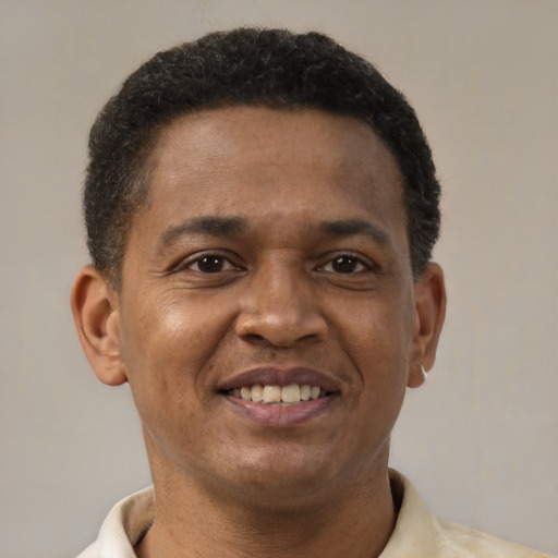 Joyful latino young-adult male with short  brown hair and brown eyes