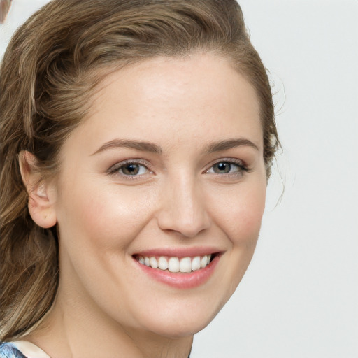 Joyful white young-adult female with long  brown hair and green eyes