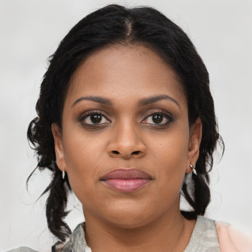 Joyful black young-adult female with medium  brown hair and brown eyes