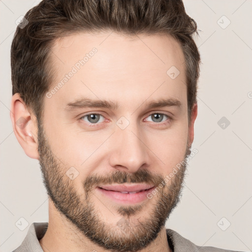 Joyful white young-adult male with short  brown hair and grey eyes